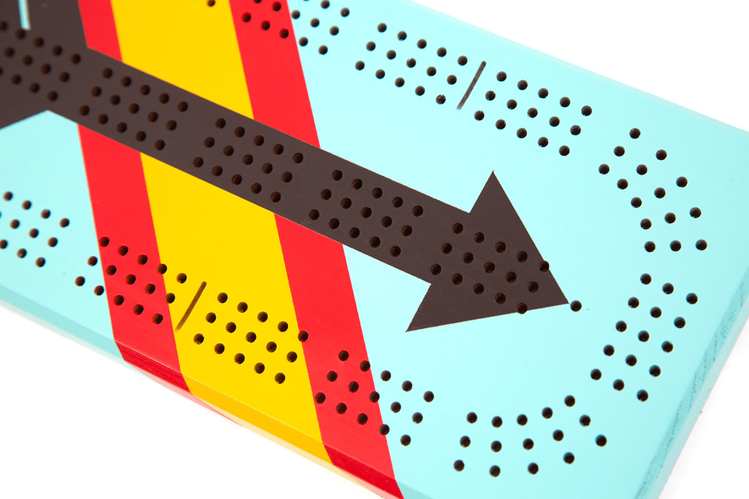 Close-up of the West Cribbage Board’s painted arrow pattern with teal, red, and yellow detailing and drilled scoring tracks.