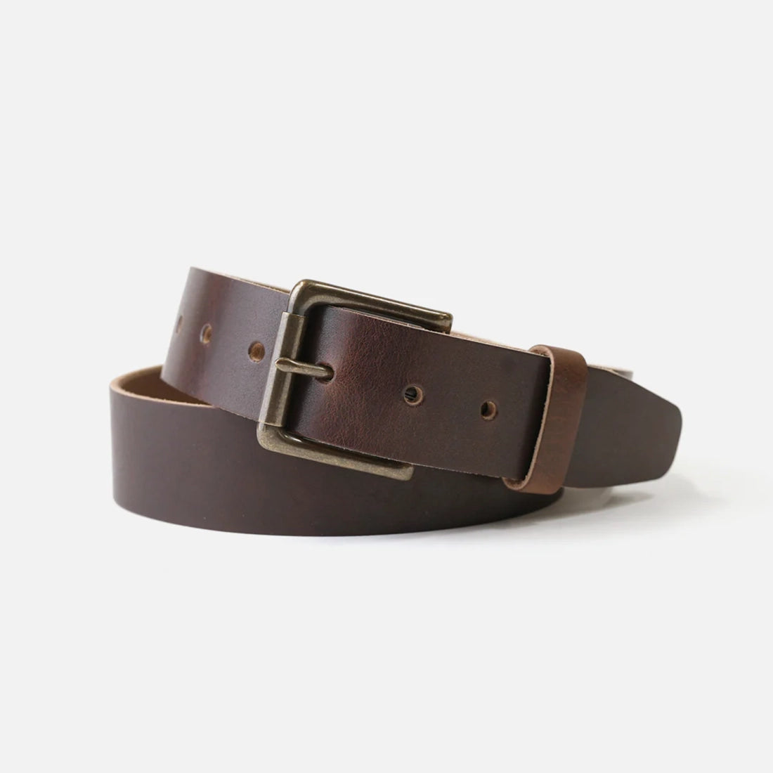 Range Leather Co. Windom Belt coiled on white background – nut brown full grain Horween leather with antique brass roller buckle
