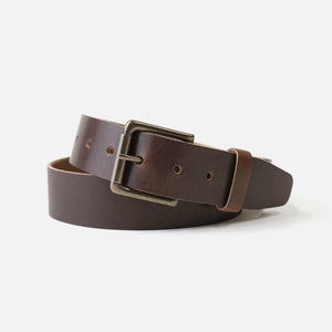 Range Leather Co. Windom Belt coiled on white background – nut brown full grain Horween leather with antique brass roller buckle