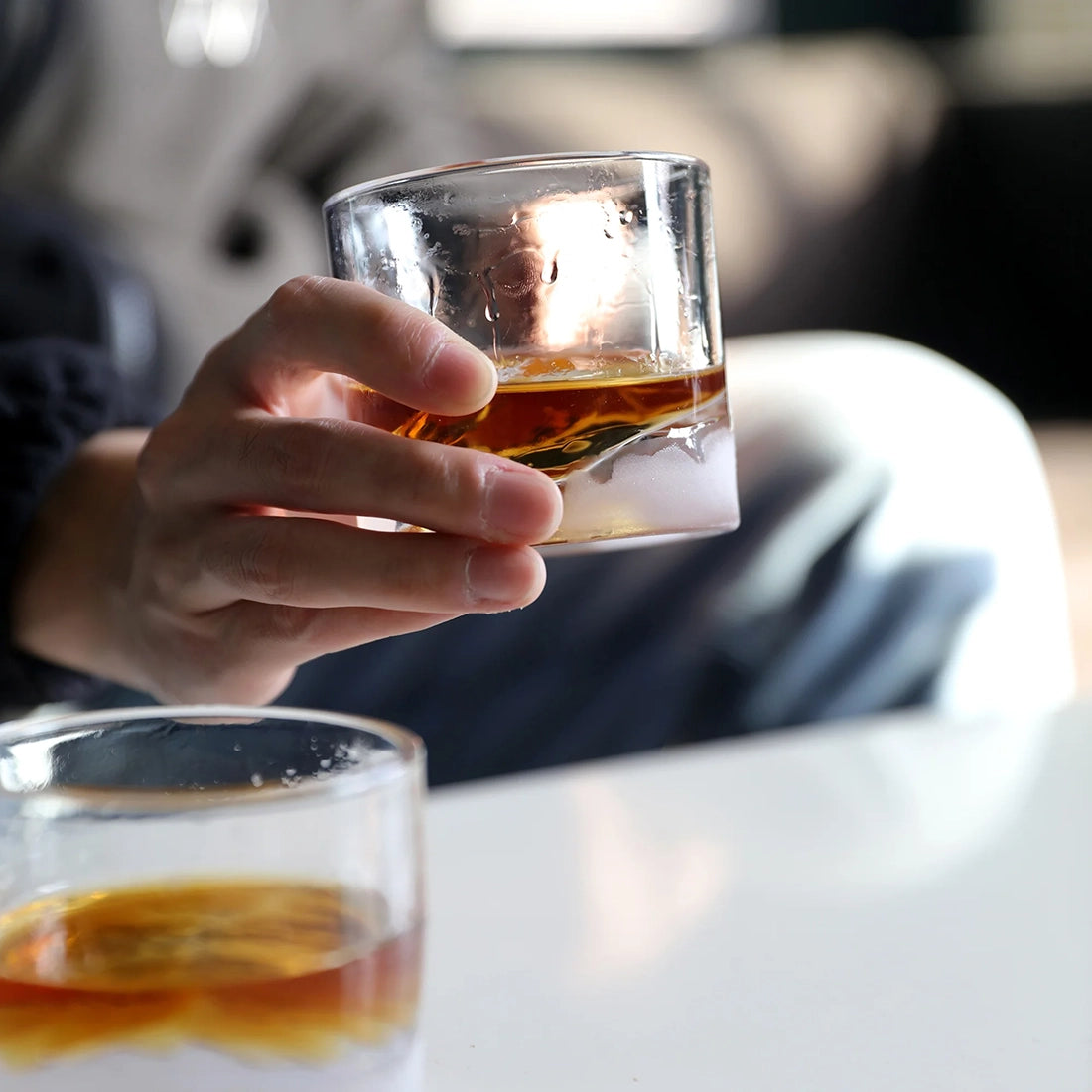 Man holding Yosemite Crystal Whiskey Glass filled with whiskey, lifestyle shot - The Simple Man