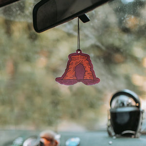 Good and Well Supply Co. Air freshener in Arches scent, shown hanging in a car