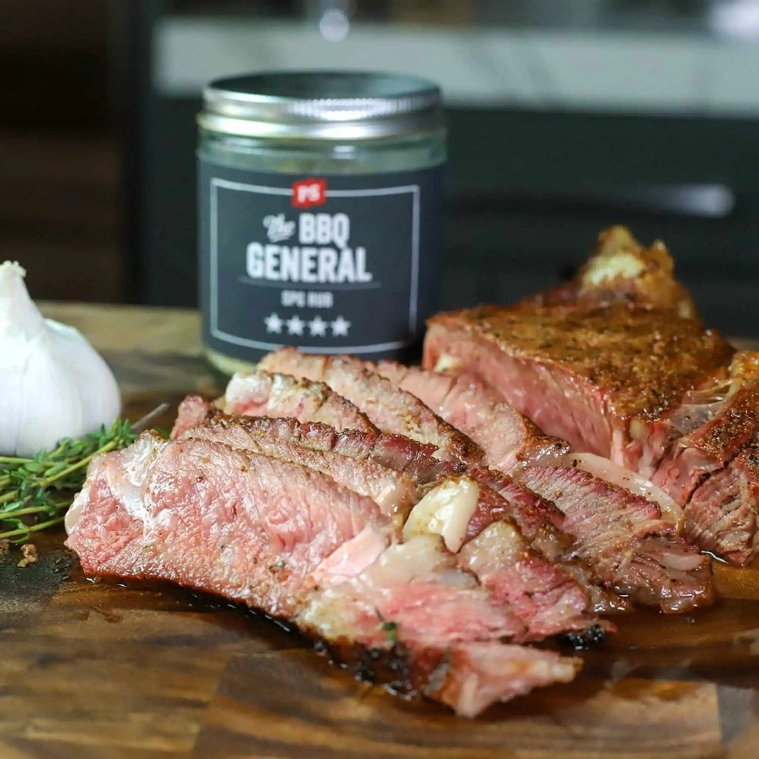 PS Seasoning BBQ General SPG rub with sliced grilled steak on cutting board and garlic – salt pepper garlic BBQ rub for brisket and steak
