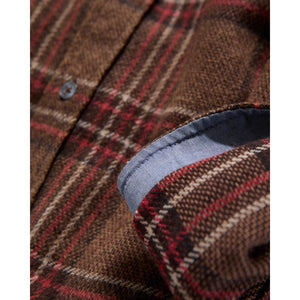 Close-up of the brown and red flannel fabric with contrast fabric at the cuff