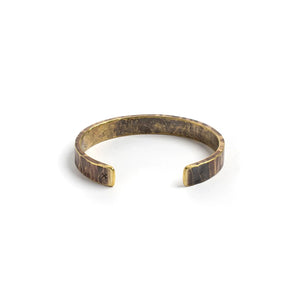 Hand-forged brass Bessemer cuff in work patina finish, heavy hammered texture, displayed on white background.