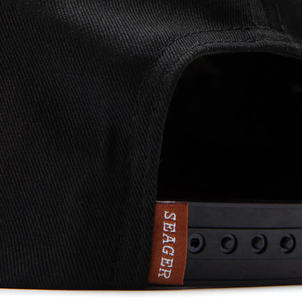 Adjustable black snapback hat with Seager tag and durable snap closure
