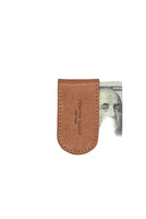 talian leather magnetic money clip securely holding folded cash – slim brown leather clip available at The Simple Man Omaha, designed for modern men’s essentials.
