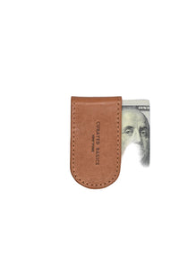 talian leather magnetic money clip securely holding folded cash – slim brown leather clip available at The Simple Man Omaha, designed for modern men’s essentials.