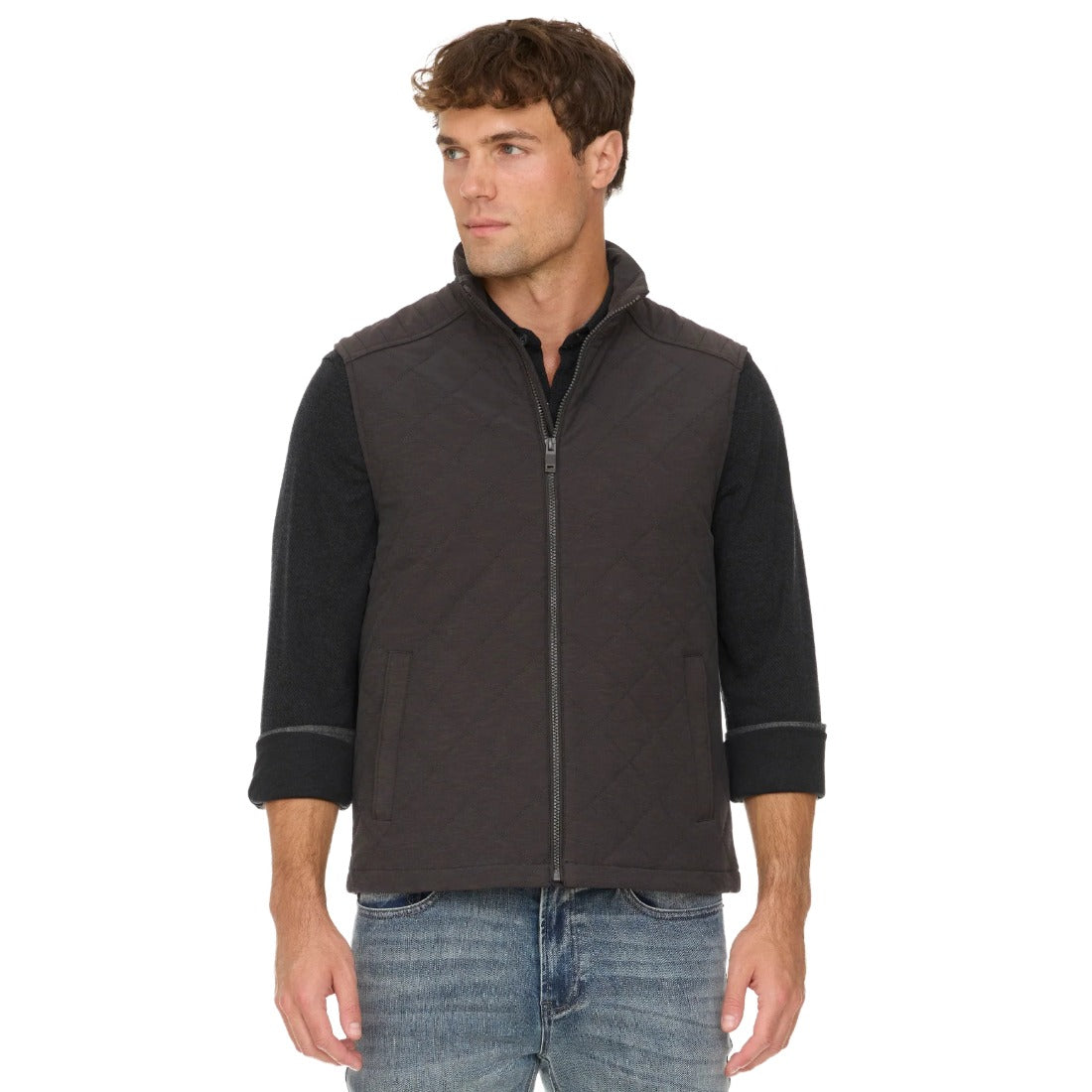 Charcoal quilted vest on a model, angled view showing the stand collar and side welt pocket