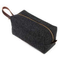 Angled top view of Charcoal Wool Travel Kit highlighting durable wool exterior and premium zipper detail