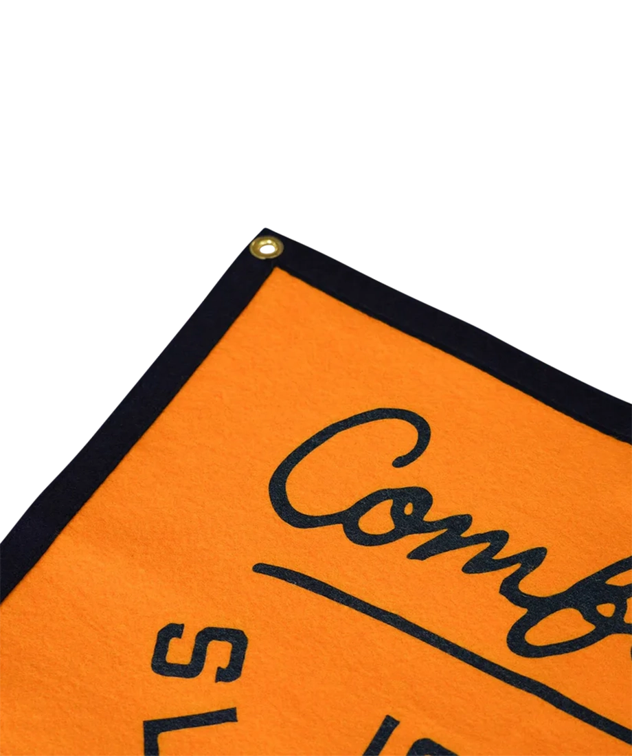 Close-up of Comfort Is a Slow Death wool camp flag corner with brass grommet