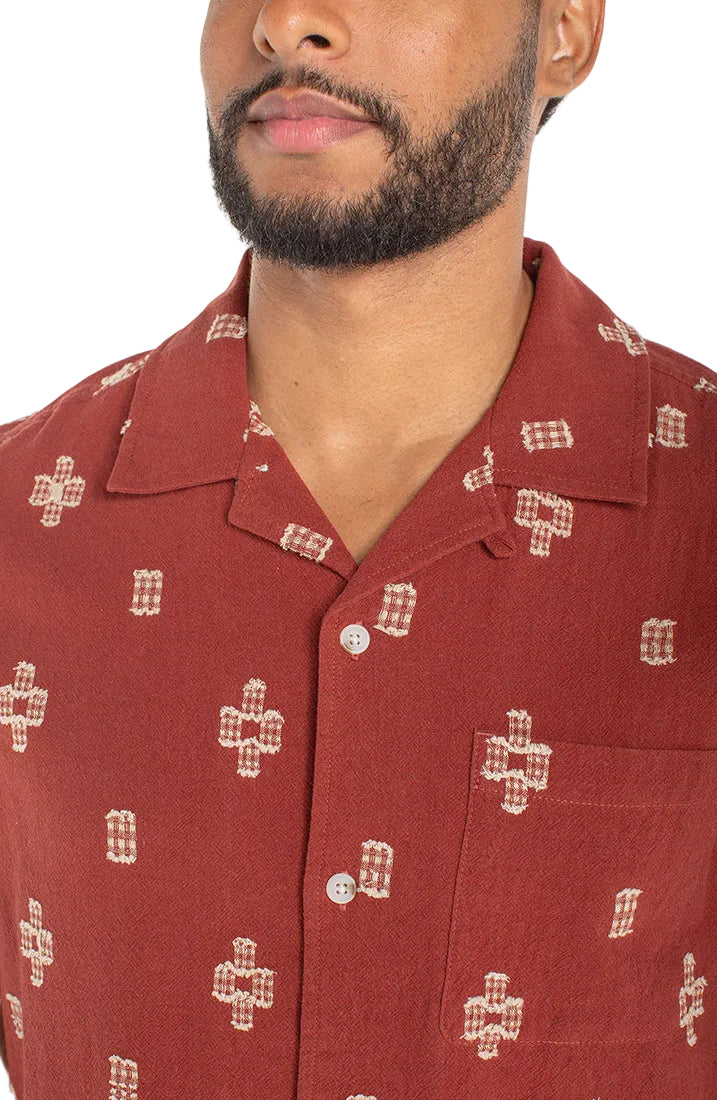 Men's red cotton jacquard camp shirt – close-up of camp collar, chest pocket, and woven geometric cross motif detail
