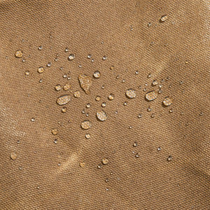 Water beading on 16oz waxed canvas surface of Readywares Deluxe Utility Apron — liquid resistant waxed cotton canvas detail