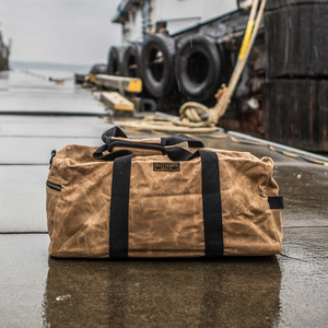 Readywares Waxed Canvas Duffel Bag, lifestyle shot on a rainy dock