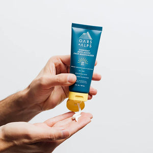 Hands dispensing lightweight men’s face moisturizer with SPF 37