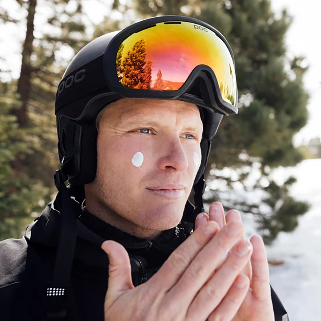 Man applying face moisturizer with SPF 37 before outdoor activity