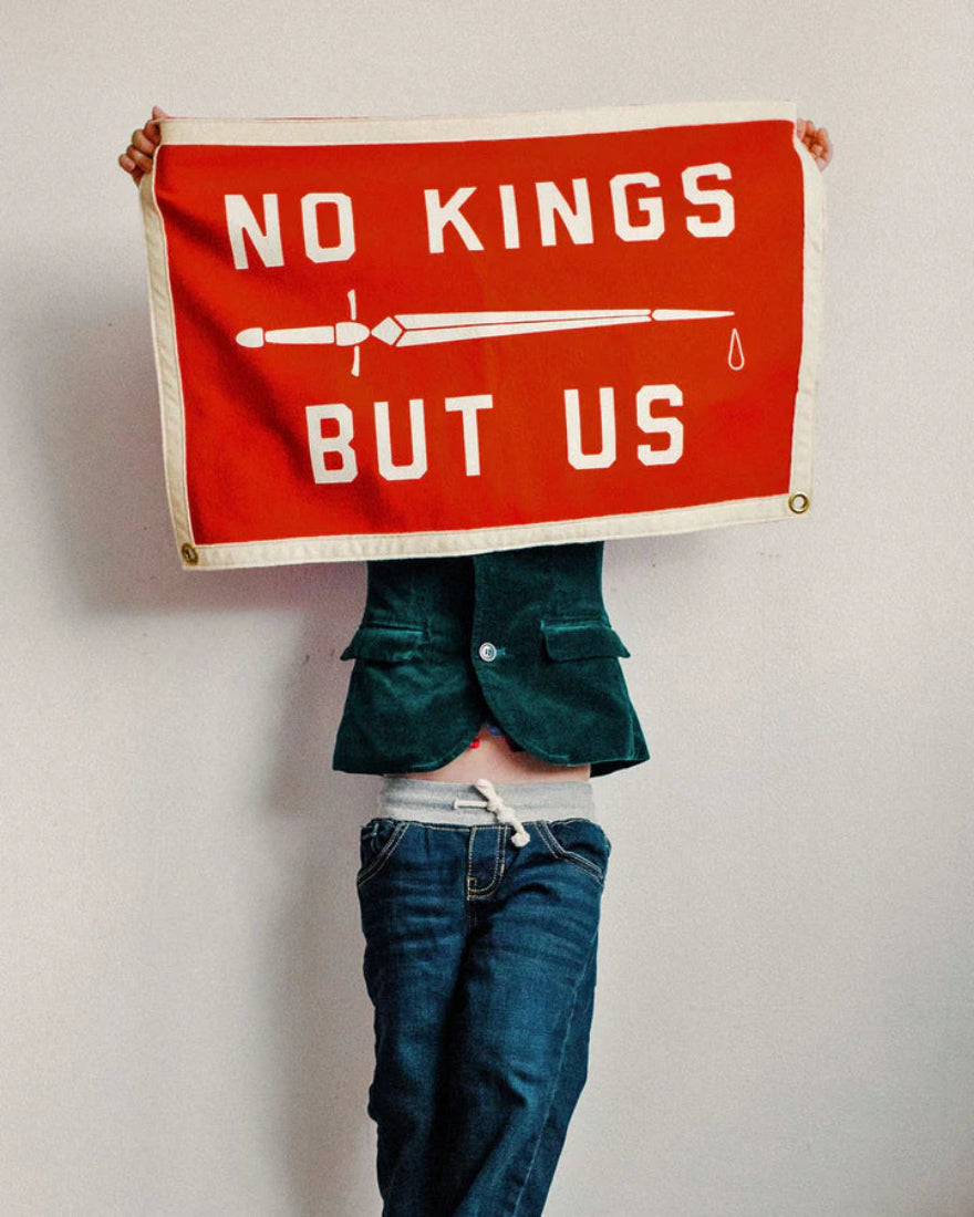 No Kings But Us camp flag hanging on wall, lifestyle photo, The Simple Man