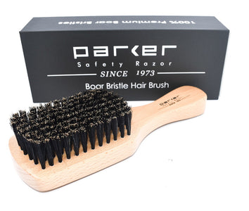 Parker boar bristle hairbrush with beechwood handle displayed in front of its branded gift box