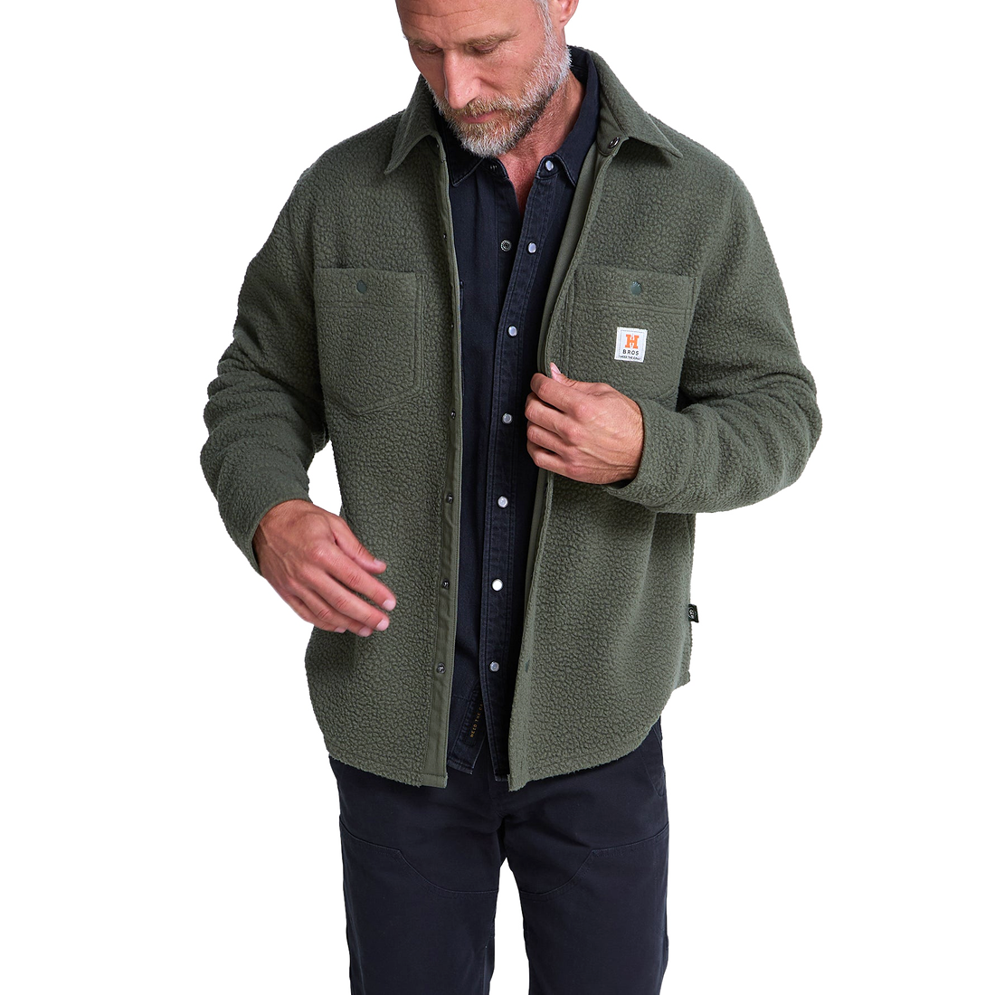 Man wearing Beetle green fleece overshirt open over a dark shirt, front view