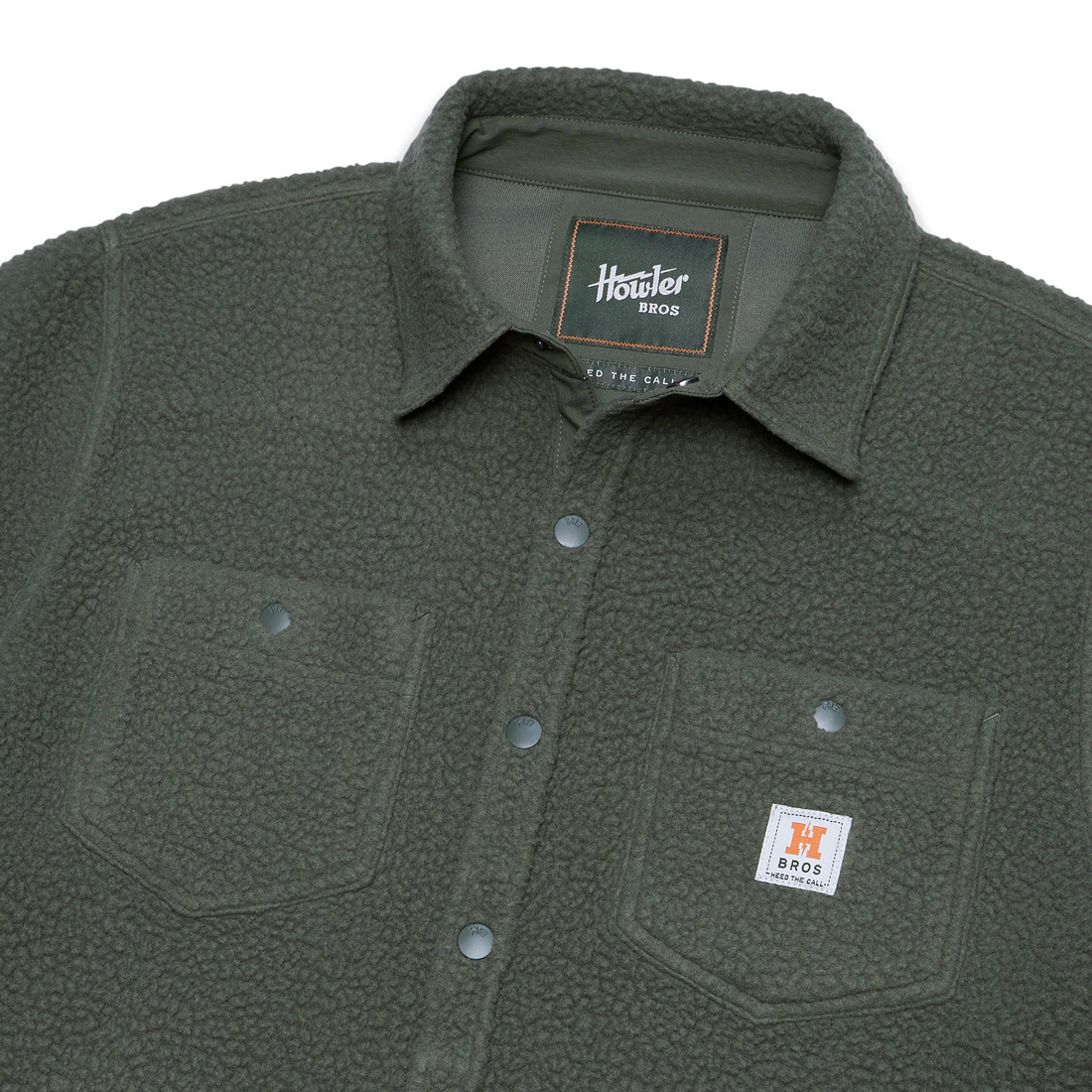 Close up of fleece overshirt collar, snaps and chest pocket label in Beetle