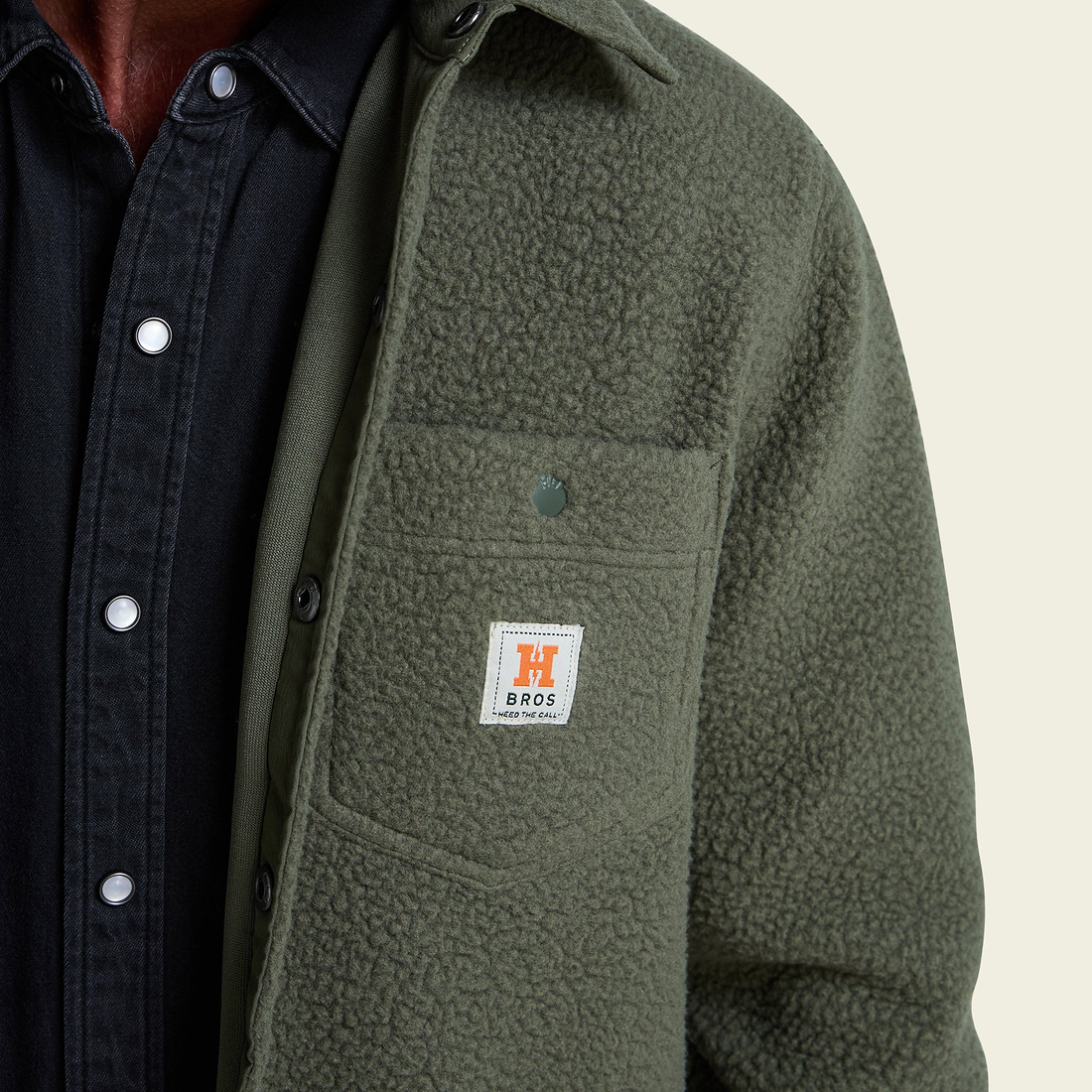 Detail of high pile fleece pocket with woven label on Beetle overshirt