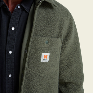 Detail of high pile fleece pocket with woven label on Beetle overshirt