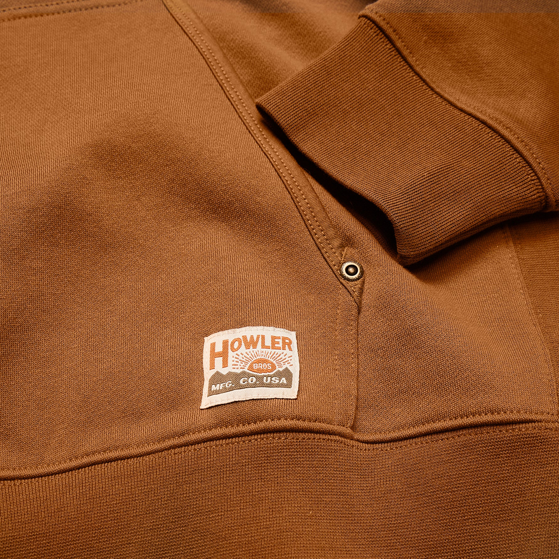 Detail of riveted pocket, ribbed cuff and mfg co badge on Workbench Trade hoodie