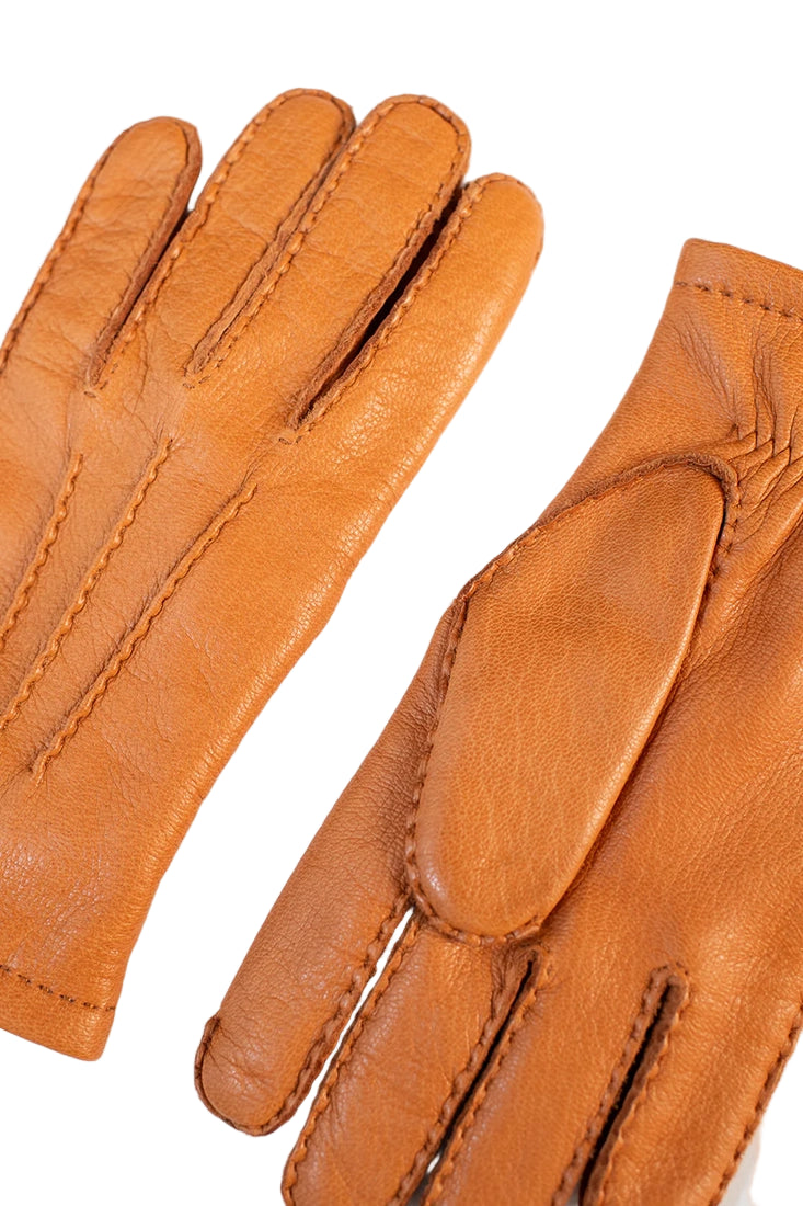 Close-up of Hestra Matthew deerskin gloves cork color showing handstitched seams and texture