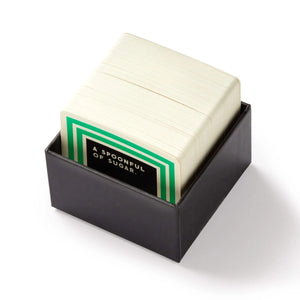 Stack of trivia cards inside the box  from Incredibly Pointless Trivia game by Brass Monkey. Contains 200 unique, sarcastic questions in a compact box—perfect for game night.