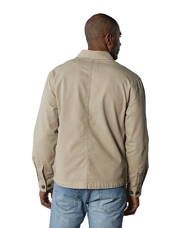 Model Wearing The Normal Brand, James Canvas Overshirt in sand dune color, rear view.