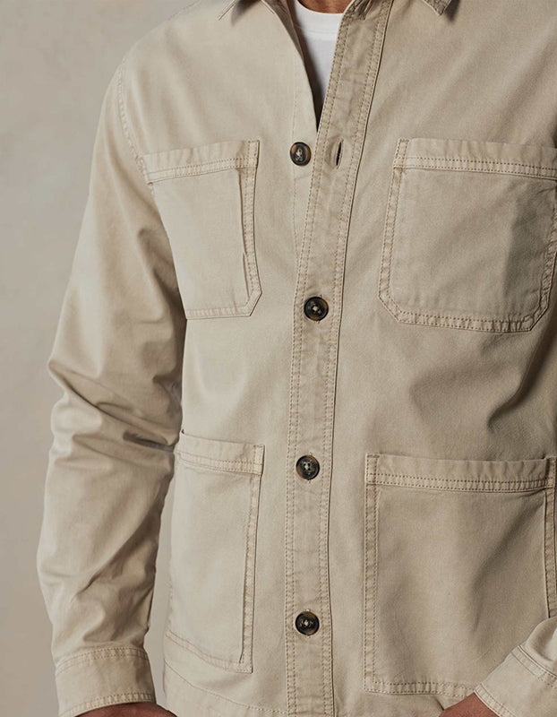 Model Wearing The Normal Brand, James Canvas Overshirt in sand dune color, Front  close up fabric detail view.