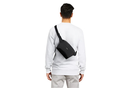 Bellroy Lite Sling Mini shown on the back of a model for size reference 