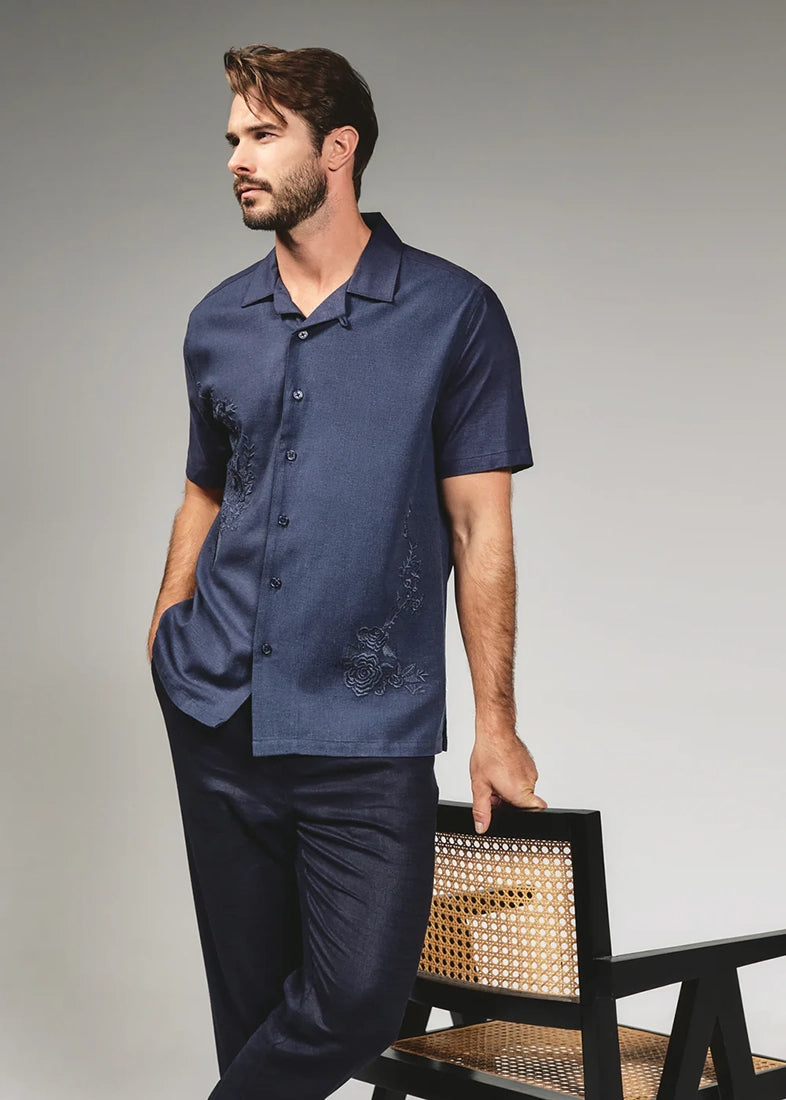 Man wearing Marco navy linen camp shirt with dark trousers – embroidered short sleeve camp collar shirt men's occasion wear