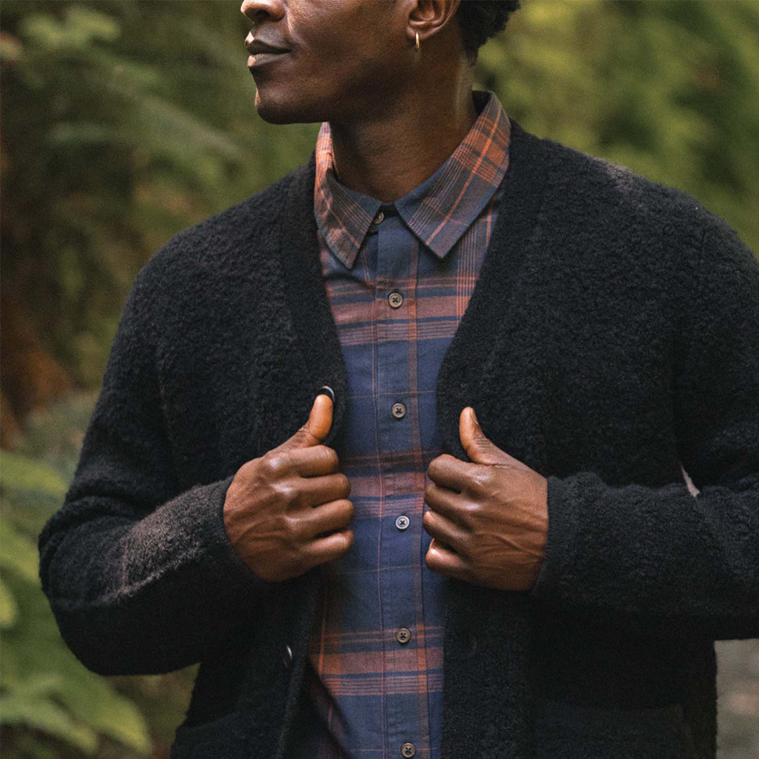 Mateo black cardigan layered over a navy and rust plaid button-up shirt - The Simple Man