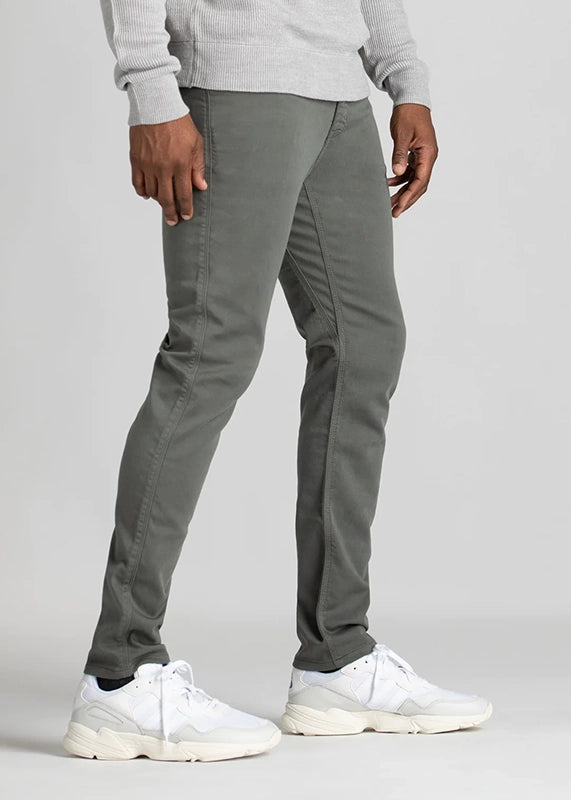 Model Wearing Duer No Sweat Slim Fit 5 Pocket pants in Gull color, Side View