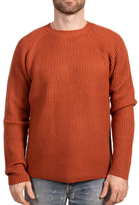 Model wearing Schott NYC merino wool ribbed crewneck sweater in rust color, front view