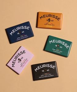 Assorted Meurisse dark chocolate mini bars from The Simple Man, featuring Himalayan Salt, Orange, Almonds, Pink Pepper, and Papua New Guinea varieties