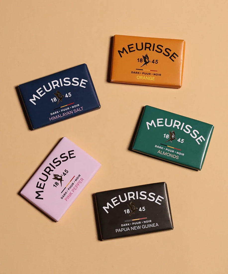 Assorted Meurisse dark chocolate mini bars from The Simple Man, featuring Himalayan Salt, Orange, Almonds, Pink Pepper, and Papua New Guinea varieties