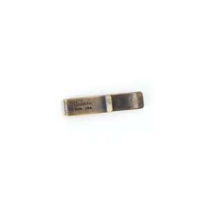 Solid brass money clip with natural patina finish, showing Studebaker PGH USA stamp on white background