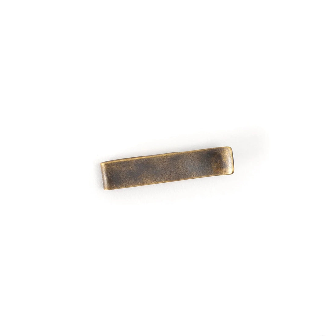 Solid brass money clip with unpolished aged patina, photographed on a clean white background