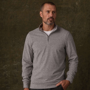 Man wearing Graphite brushed knit quarterzip with hand in pocket, front view