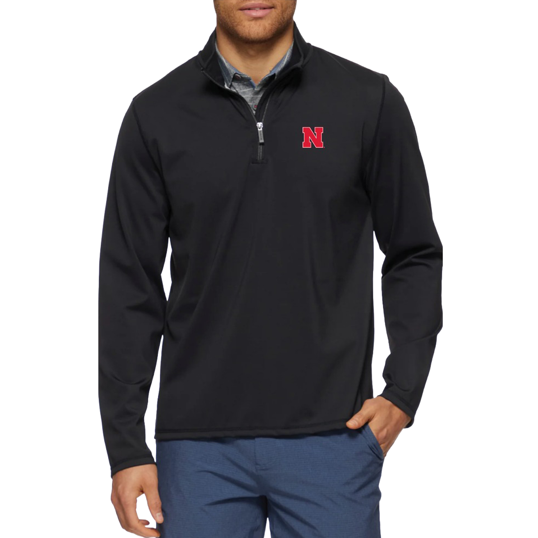 Man wearing a Nebraska Cornhuskers black performance quarter-zip mock neck with a red N on the chest