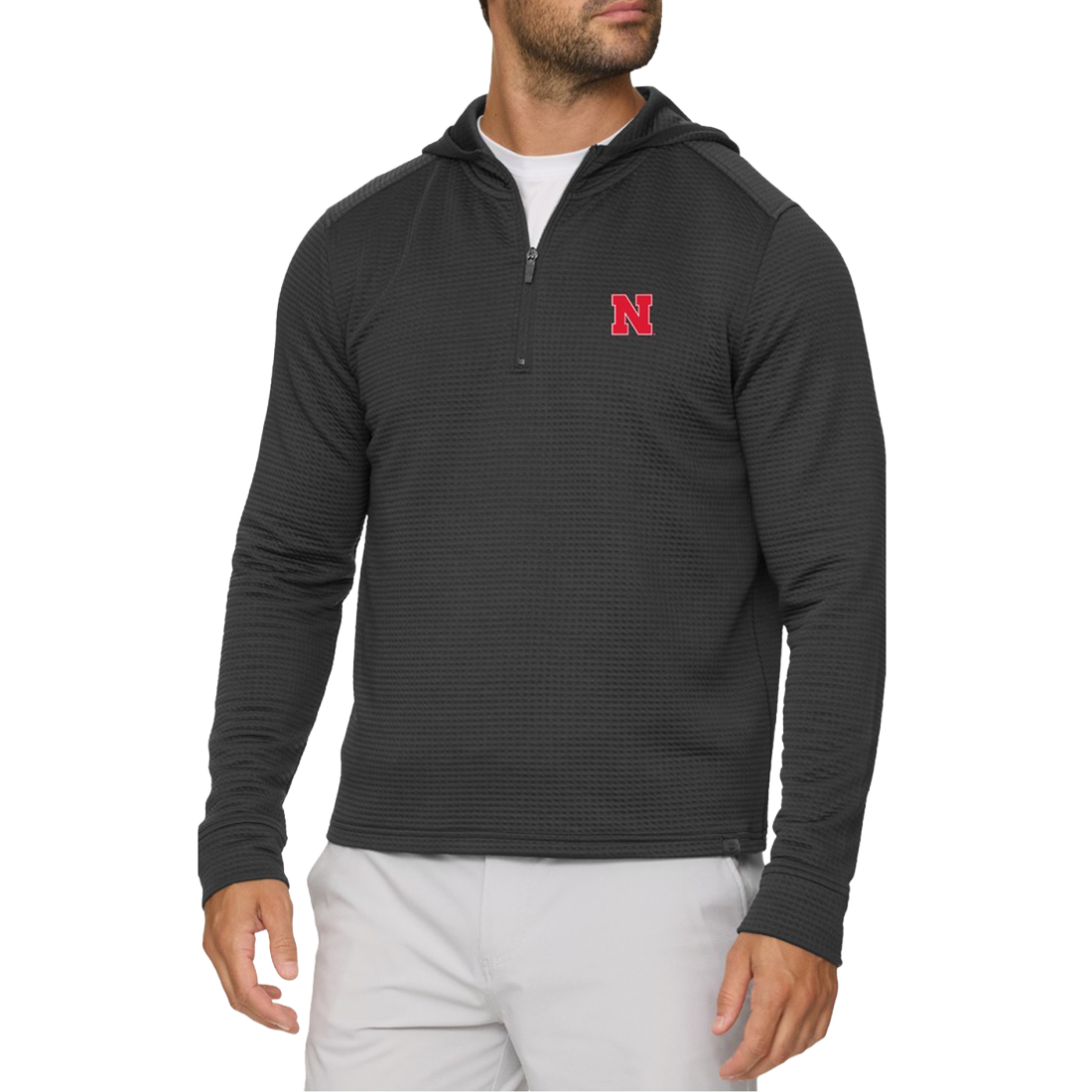 Man wearing a Nebraska Cornhuskers black waffle quarter-zip hoodie with a red N on the left chest