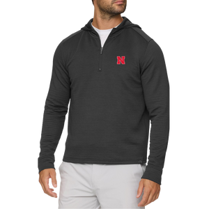 Man wearing a Nebraska Cornhuskers black waffle quarter-zip hoodie with a red N on the left chest