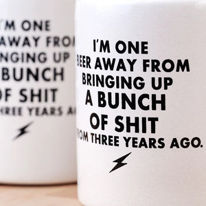 Close-up of the Vintage “One Beer Away” Koozie showing the bold black text printed on the white foam sleeve, sold by The Simple Man in Omaha.