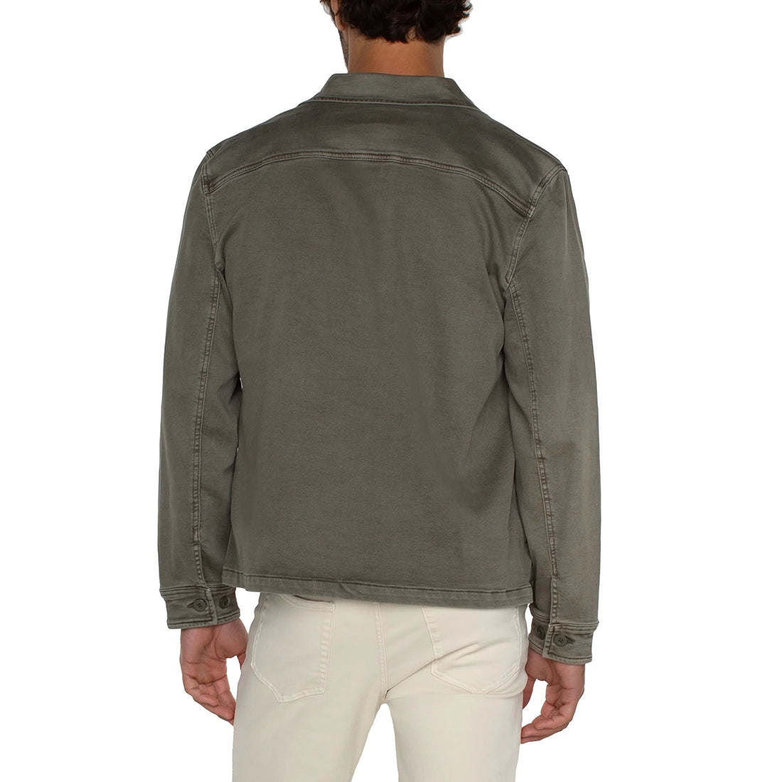 Person wearing a green jacket on a white background