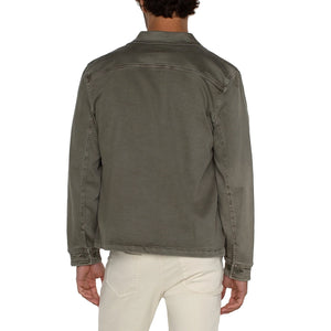 Person wearing a green jacket on a white background