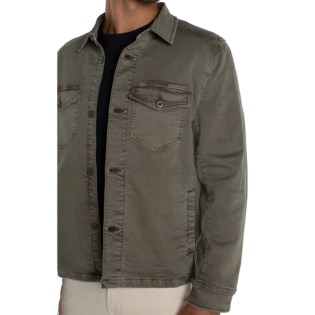 Green jacket worn by a person on a white background