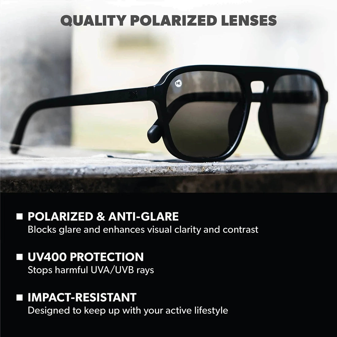 Knockaround Pacific Palisades polarized black smoke lenses on stone surface — UV400 protection impact resistant anti-glare sunglasses
