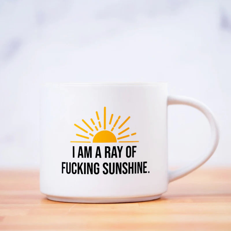 Ceramic coffee mug with "I am a ray of fucking sunshine" screened on it with a yellow sun.