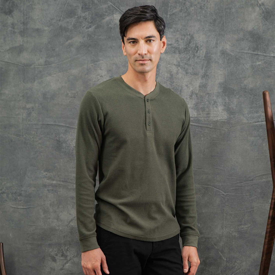 Man wearing the recycled waffle henley in Forest Melange with black pants, front view - The Simple Man